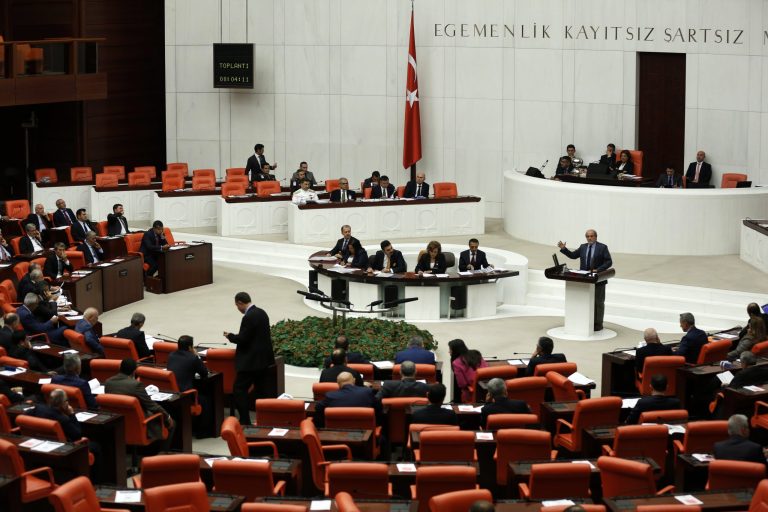 Lawmakers debate before Turkey's parliament approved a motion that gives the government new powers to launch military incursions into Syria and Iraq and to allow foreign forces to use its territory for possible operations against the Islamic State group, in Ankara, Turkey, Thursday, Oct. 2, 2014. (AP Photo)