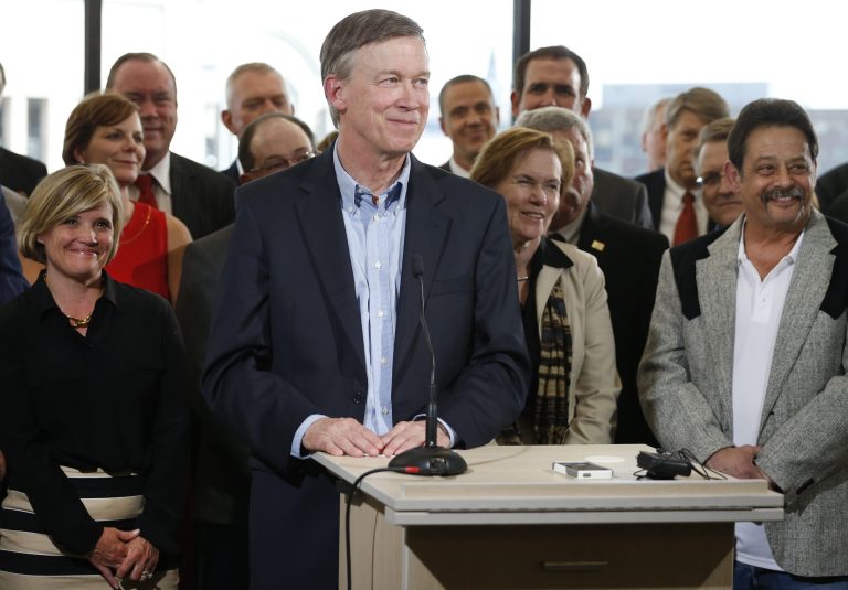 Colo. Gov. John Hickenlooper, center, takes questions after speaking on oil and gas drilling at the Metro Denver Chamber of Commerce, Thursday, July 17, 2014. Hickenlooper spoke about his opposition to proposed Colorado ballot measures to limit hydrocarbon extraction. The oil and gas industry says those measures would ban drilling, though supporters of the ballot measures disagree. (AP Photo/Brennan Linsley)