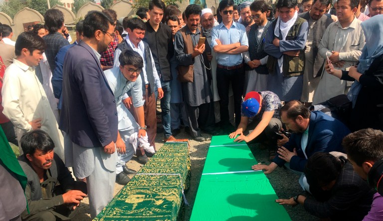 Relatives pray near to the dead bodies of civilians after Wednesday's deadly suicide bombing that targeted a training class in a private building in the Shiite neighborhood of Dasht-i Barcha, in western Kabul, Afghanistan, Thursday, Aug. 16, 2018.