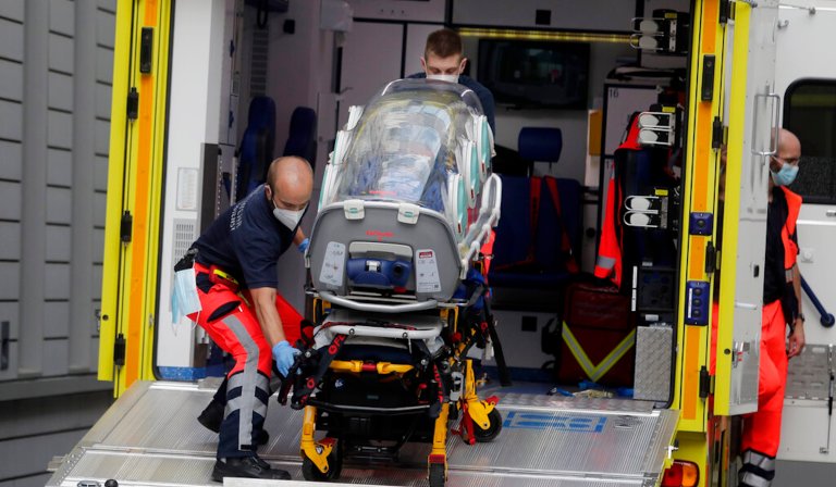 An empty stretcher is carried back into an ambulance which is believed to have transported Alexei Navalny at the emergency entrance of the Charite hospital in Berlin, Germany, Saturday, Aug.22, 2020. The dissident who is in a coma after a suspected poisoning has been transferred from the Siberian city of Omsk. Navalny is flown to Germany to receive treatment. 