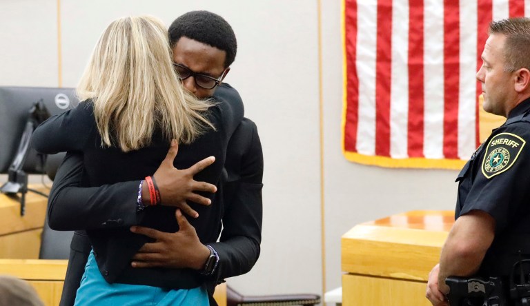 Botham Jean's younger brother Brandt Jean hugs convicted murderer and former Dallas Police Officer Amber Guyger after delivering his impact statement to her after she was sentenced to 10 years in jail, Wednesday, Oct. 2, 2019, in Dallas. 