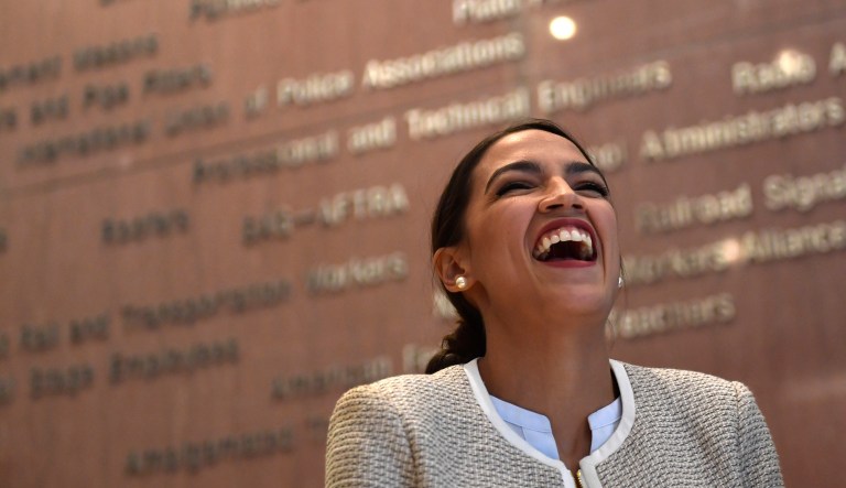 Rep.-elect Alexandria Ocasio-Cortez, D-N.Y., laughs as another speaker talks about her during a news conference with members of the Progressive Caucus in Washington, Monday, Nov. 12, 2018.