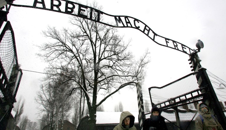 FILE - In this Jan. 26, 2005 file photo visitors walk through the entrance gate of the Auschwitz Nazi concentration camp in Oswiecim, southern Poland, a day before the commemorations of the 60th anniversary of the liberation of the Auschwitz Nazi concentration camp by Soviet troops.  Polish police say the infamous iron sign over the gate to the Auschwitz memorial site with the cynical phrase "Arbeit Macht Frei" _ German for "Work Sets You Free" _ has been stolen. Police spokeswoman Katarzyna Padlo said police believe it was stolen between 3:30 a.m. and 5 a.m. Friday, Dec. 18, 2009, when museum guards noticed that it was missing and alerted police. 