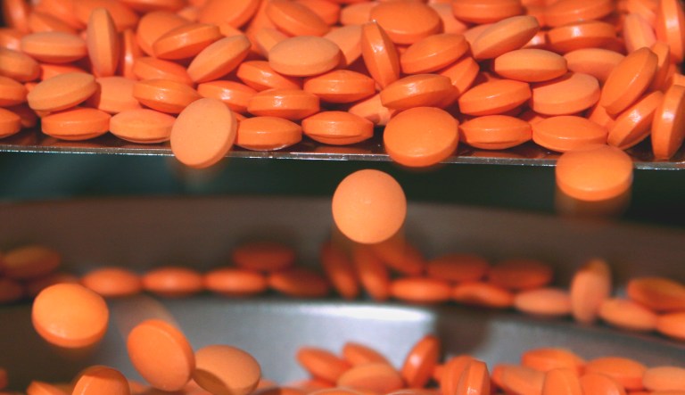 Pills move through a precision weighing machine at the Interphex2006 pharmaceutical manufacturers trade show in New York.