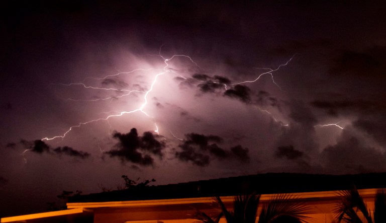 Lightning fills the sky behind a home in Florida.