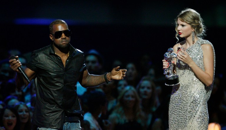Singer Kanye West takes the microphone from singer Taylor Swift as she accepts the "Best Female Video" award during the MTV Video Music Awards in New York. 