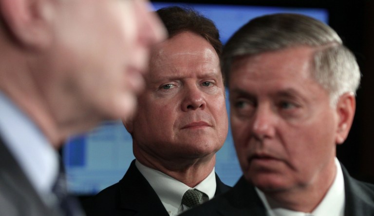 Sen. Jim Webb, D-Va., center, flanked by Sen. John McCain, R-Ariz., left, and Sen. Lindsey Graham, R-S.C., looks on during a news conference on Capitol Hill in Washington, Tuesday, Feb. 2, 2010, to discuss the terror trials.