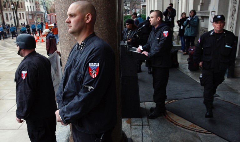 Jeff Schoep, leader of the National Socialist Movement addresses supporters from the steps of the Trenton, NJ, Statehouse surrounded by neo-Nazi guards. Saturday, April 16, 2011. (AP Photo/Mel Evans)