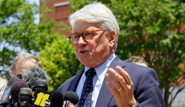 Greg Craig is seen talking to the media.