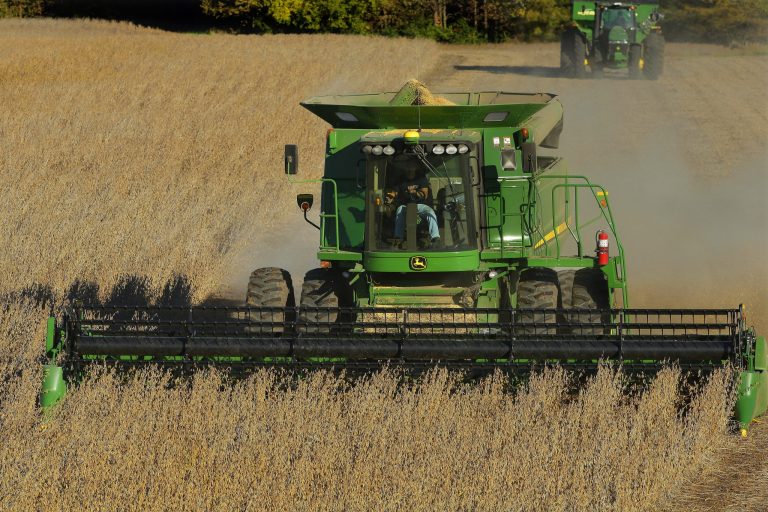 In this 2014 photo, a central Illinois farmer uses a John Deere combine to harvest his soybean field in Loami, Ill.