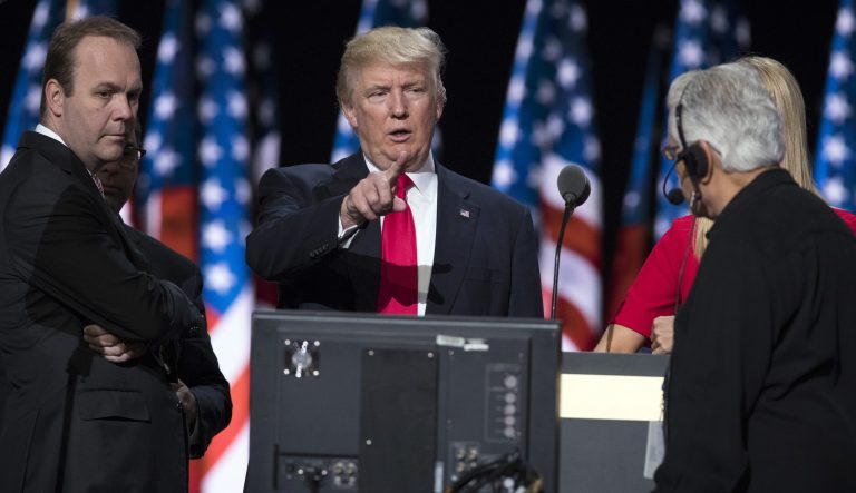 In this July 21, 2016 photo, Republican presidential candidate Donald Trump, center, accompanied by Trump campaign aide Rick Gates, left, prepares for his speech at the Republican National Convention in Cleveland.