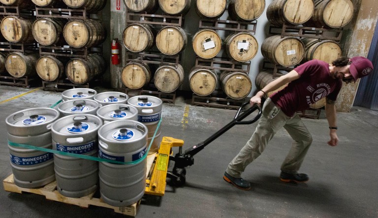 Cellerman Franz Graef passes a wall of barrel-aged beers as he pulls a pallet of filled kegs to a walk-in refrigerator at Rhinegeist Brewery in the Over-the-Rhine neighborhood of downtown Cincinnati.