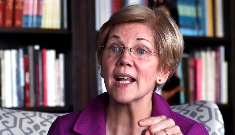 Sen. Elizabeth Warren, D-Mass., gestures as she answers a question during an interview at her office in Boston.