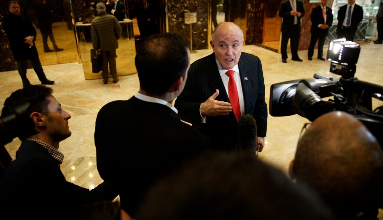 Former New York City Mayor Rudy Giuliani talks with reporters in the lobby of Trump Tower in New York, Thursday, Jan. 12, 2017. 