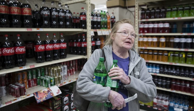 In this March 16, 2017 photo, Margaret Atkinson speaks during an interview as she shops for soda at the IGA supermarket in the Port Richmond neighborhood of Philadelphia less than three months into Philadelphia's new tax on sweetened drinks. 