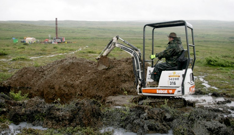 A worker with the Pebble Mine project digs in the Bristol Bay region of Alaska near the village of Iliamma, Alaska. 