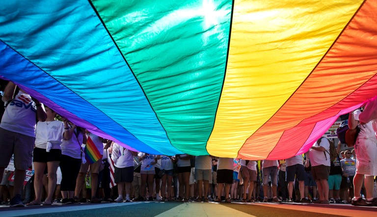 Marchers unfurl a huge rainbow flag as they prepare to march in the Equality March for Unity and Pride in D.C.,  June 11, 2017.