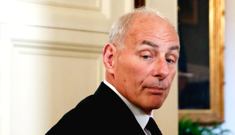 White House chief of staff John Kelly, right, departs the East Room of the White House in Washington.