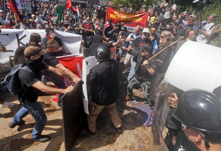 White nationalist demonstrators clash with counter demonstrators at the entrance to Lee Park in Charlottesville, Va., August 2017. Gov. Terry McAuliffe had declared a state of emergency and police dressed in riot gear ordered people to disperse after chaotic violent clashes between white nationalists and counter protesters. 