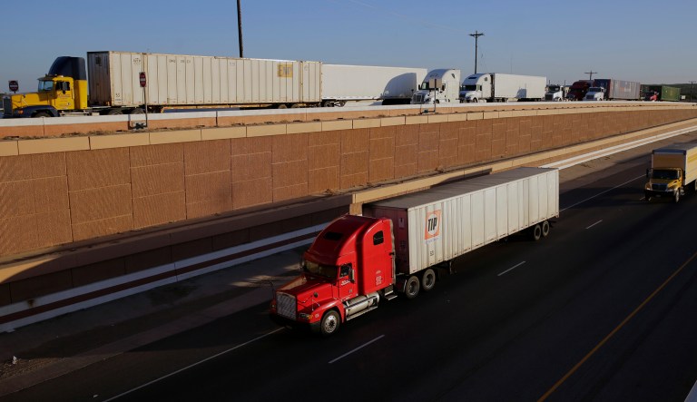 FILE - In this Monday, Nov. 21, 2016, file photo, trucks move along Interstate 35, in Laredo, Texas. U.S. President Donald Trump's campaign promise to abandon the North American Free Trade Agreement helped win over Rust Belt voters who felt left behind by globalization. But the idea is unnerving to many people in cities on the U.S.-Mexico border, like Laredo. Five days of talks aimed at overhauling NAFTA begin Wednesday, Aug. 16, 2017, in Washington, with negotiations to follow in Mexico and Canada.