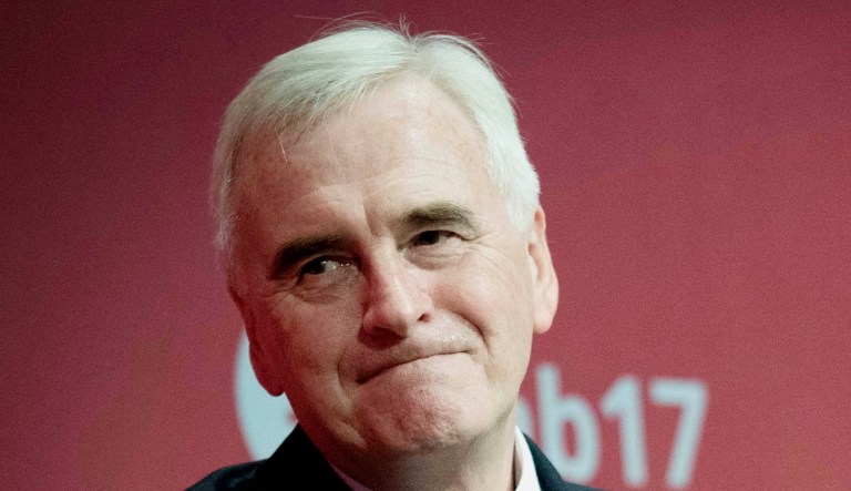 Britain's Shadow chancellor John McDonnell, left, is congratulated by Labour Party leader Jeremy Corbyn  after his speech at the Labour Party conference at the Brighton Centre, Brighton, England, Monday Sept. 25, 2017.