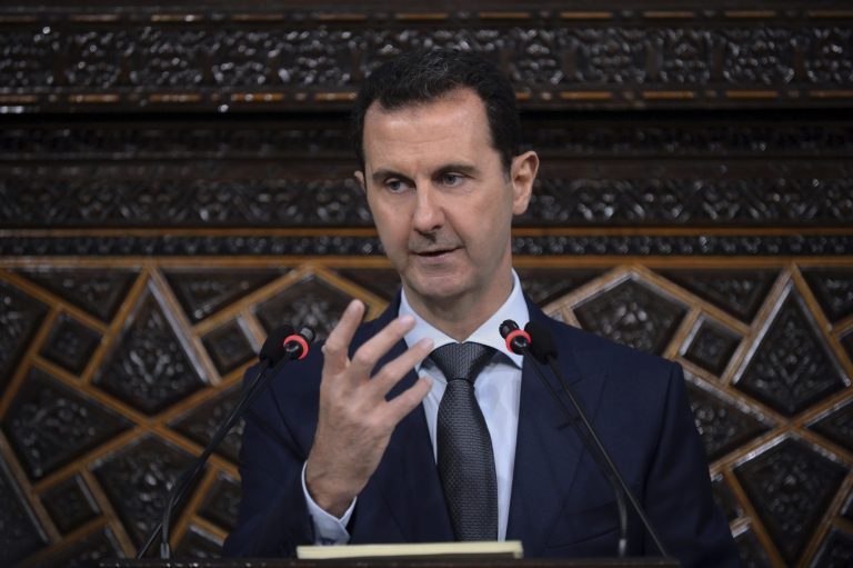 In this file photo released by the Syrian official news agency SANA, Syrian President Bashar Assad addresses a speech to Syria's parliament at the parliament building in Damascus, Syria.