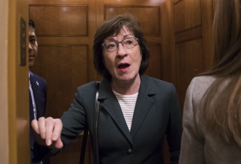 With reporters looking for updates, Sen. Susan Collins, R-Maine, pauses in an elevator for a reporter's question as senators head to the chamber.