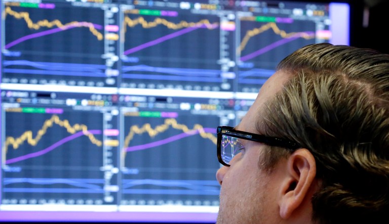 Specialist Gregg Maloney works at his post on the floor of the New York Stock Exchange.