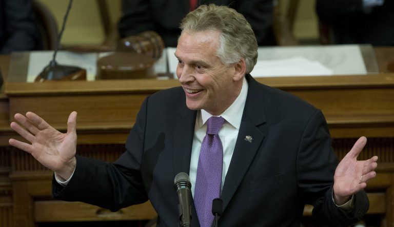 Then-Virginia Gov. Terry McAuliffe gestures as he arrives to address a joint session of the the 2018 session in the House chambers at the Capitol in Richmond, Va., Wednesday, Jan. 10, 2018. 