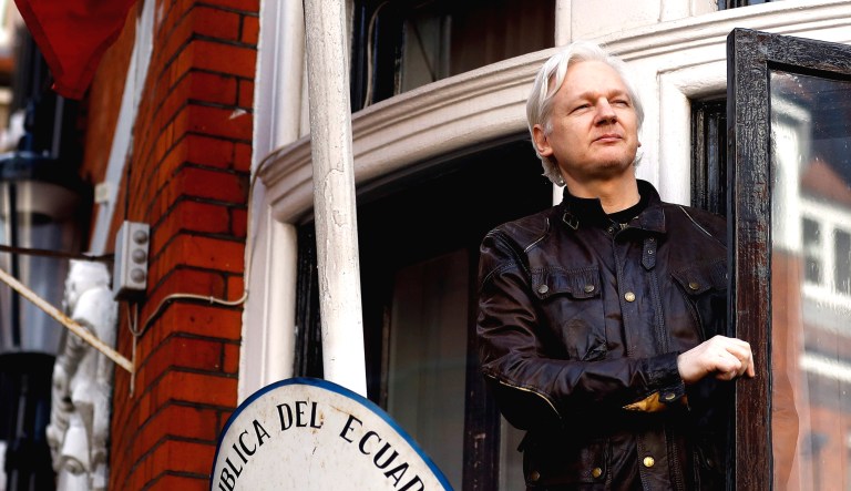 WikiLeaks founder Julian Assange greets supporters outside the Ecuadorian embassy in London.