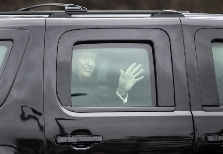 President Donald Trump waves from his motorcade vehicle as he arrives to board Marine One to leave Walter Reed National Military Medical Center in Bethesda, Md., Friday, Jan. 12, 2018, after his first medical check-up as president.