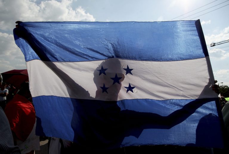A person holds a Honduran flag in Tegucigalpa, Honduras on Friday.