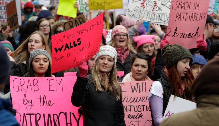 Marchers carry signs during the Women's March on Jan. 20, 2018, in Seattle.