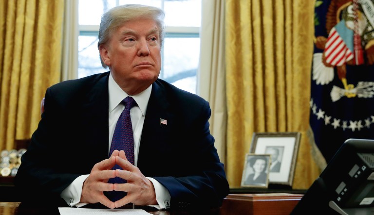 President Trump sits in the Oval Office of the White House in Washington.