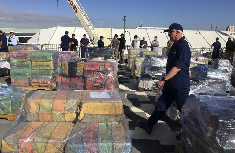 US Coast Guard Pacific area commander, Vice Adm. Fred Midgette, right, walks by bundles of cocaine aboard the US Coast Guard Cutter Stratton in San Diego on Thursday, Jan. 25, 2018.