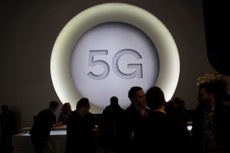 People stand next to a 5G logo during the Mobile World Congress wireless show, in Barcelona, Spain.