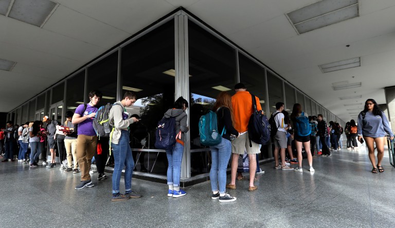 A line of mostly students wait to vote at a Texas primary election polling site on the University of Texas campus in Austin, Texas.