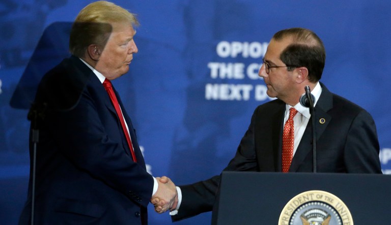 President Donald Trump shakes hands with Health and Human Services Secretary Alex Azar, right, during an event about combating opioid drug addiction at Manchester Community College, Monday, March 19, 2018, in Manchester, N.H. 