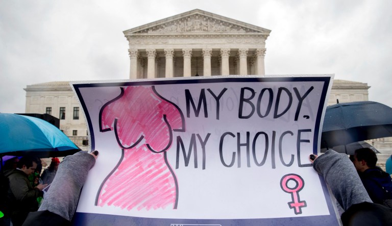 A pro-cabortion rights supporter holds up a sign that reads "My Body. My Choice" during a rally outside the Supreme Court in Washington, as the Supreme Court hears arguments in a free speech fight over California's attempt to regulate anti-abortion crisis pregnancy centers.