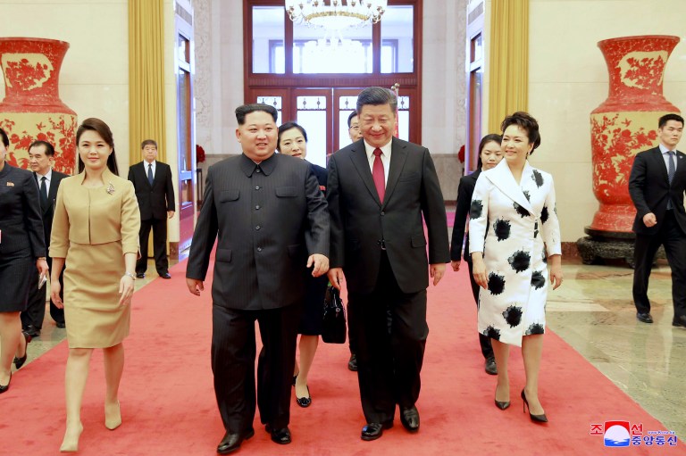 In this photo from Monday, North Korean leader Kim Jong Un (center left) and his wife Ri Sol Ju (left) are accompanied by his Chinese counterpart Xi Jinping (center right) and his wife, Peng Liyuan, at the Great Hall of the People in Beijing.