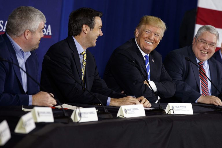 President Donald Trump smiles during a roundtable discussion on tax policy, Thursday, April 5, 2018, in White Sulphur Springs, W.Va., with from left, Service Pump and Supply principal engineer Sean Farrell, Rep. Evan Jenkins, R-W.Va., and West Virginia Attorney General Patrick Morrisey.