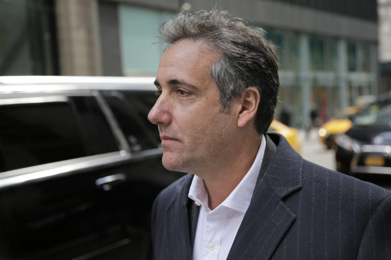 Michael Cohen walks down the sidewalk in New York City.