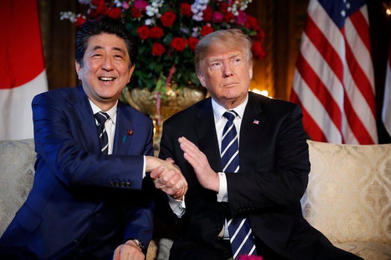 FILE - In this April 17, 2018 file photo, President Donald Trump and Japanese Prime Minister Shinzo Abe speak during a meeting at Trump's private Mar-a-Lago club, in Palm Beach, Fla. Japan has reported that its trade surplus with the U.S. grew nearly 6 percent in the fiscal year through March, 2018. The trade figures were released Wednesday, April 18, 2018,  as Prime Minister Shinzo Abe was in the U.S. for meetings with President Donald Trump, who has complained repeatedly about the trade imbalance with Japan.