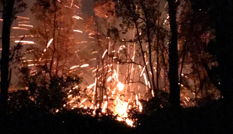 This photo provided by Shane Turpin shows results of the eruption from Kilauea Volcano on Hawaii's Big Island Friday. The eruption sent molten lava through forests and bubbling up from paved streets and forced the evacuation of about 1,500 people who were still out of their homes Friday after Thursday's eruption.