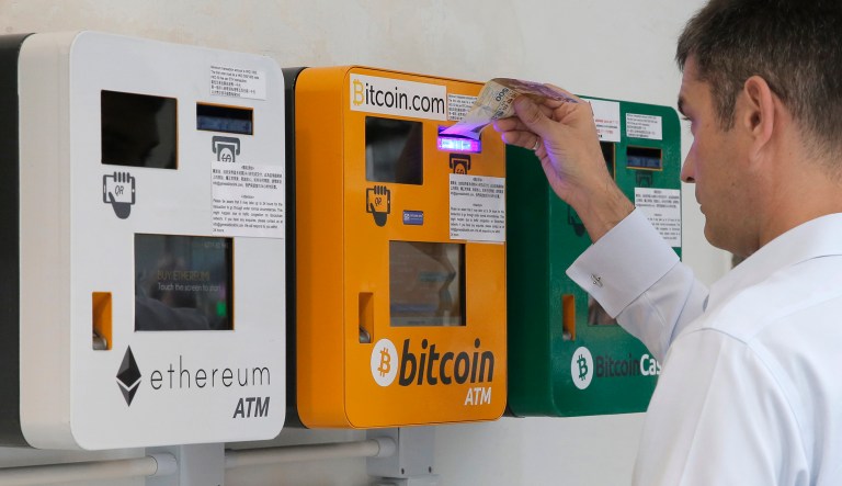 A man uses a Bitcoin ATM in Hong Kong, Friday, May 11, 2018.
