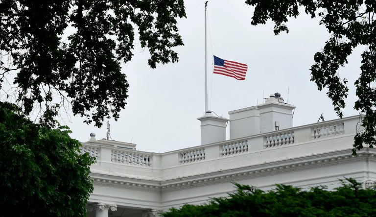 The American flag is lowered to half-staff at the White House in Washington. 