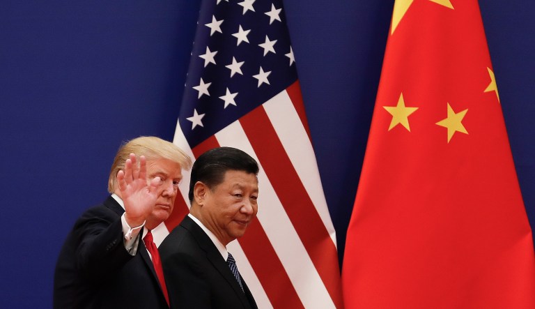 President Trump waves next to Chinese President Xi Jinping after attending a business event at the Great Hall of the People in Beijing on Nov. 9, 2017.