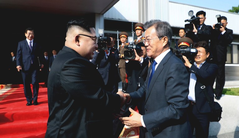 In this May 26 photo provided by South Korea's Presidential Blue House via Yonhap News Agency, North Korean leader Kim Jong Un, left, and South Korean President Moon Jae-in, right, shake hands.
