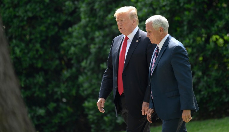 President Trump walks with Vice President Mike Pence as he heads toward Marine One on the South Lawn of the White House in Washington, Tuesday, May 29, 2018.