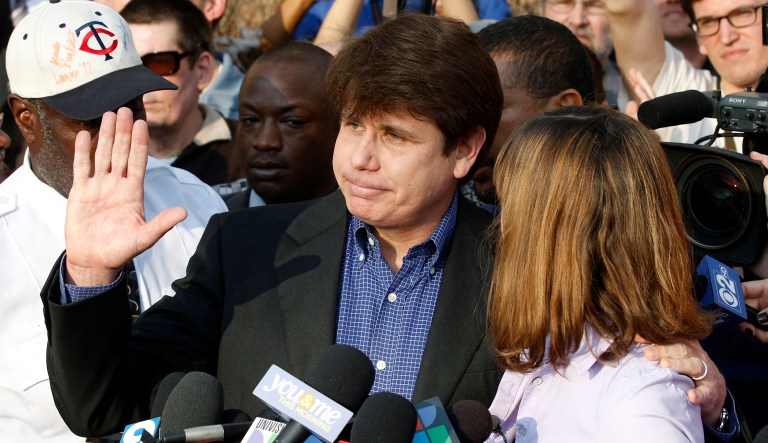 Former Illinois Gov. Rod Blagojevich, with his wife Patti at his side, speaks to the media in Chicago before reporting to federal prison in Denver.
